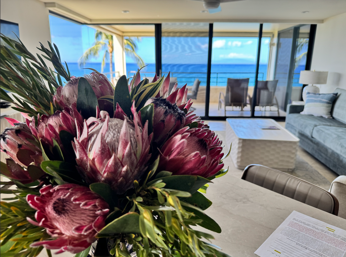Fresh protea room drop arrangement in a Maui guest room with an ocean view